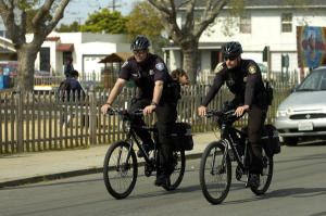 Richmond police officers Matt Stonebraker, left, and Anthony Diaz ride on patrol in Richmond, Calif., on Wednesday, March 13, 2013.